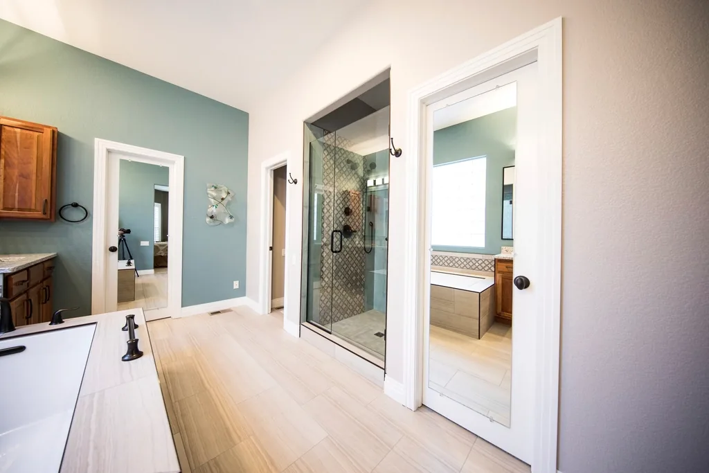 Bathroom with blue walls and a glass shower