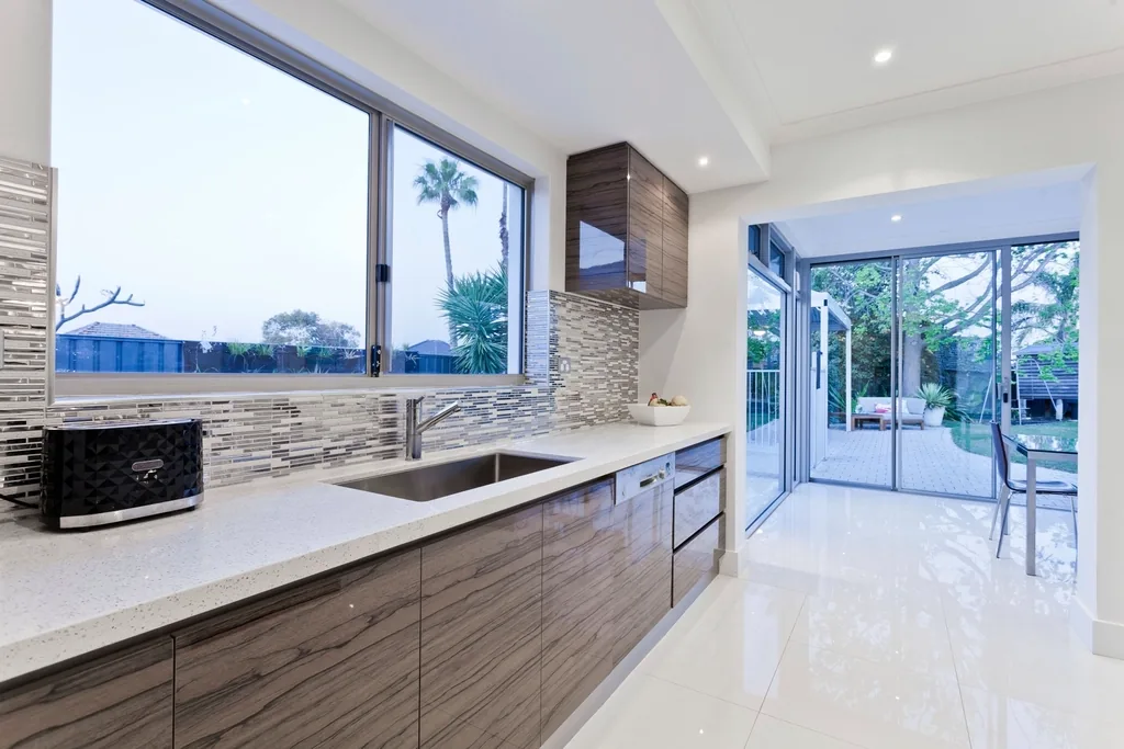 Kitchen with wood cabinets and a wide window
